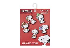 the peanuts character stickers are on display in front of a red card with white writing