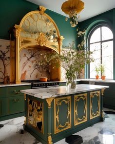 an ornate kitchen with green cabinets and marble counter tops, gold trim on the island