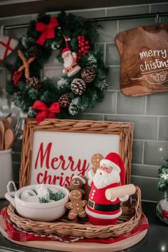 a santa clause figurine sitting on top of a counter next to a christmas sign