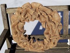 a wreath on a wooden bench in the snow