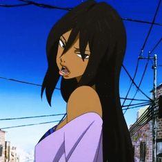 a woman with long black hair standing in the street