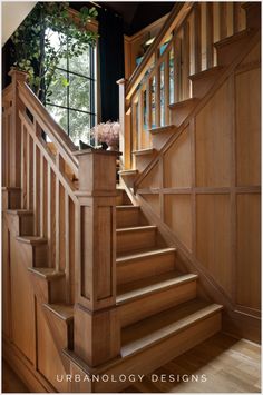 a wooden staircase leading up to a window