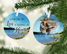 two ornament ornaments with fishing images hanging from a christmas tree, one has a fisherman and the other is saying someone we love fishing in heaven