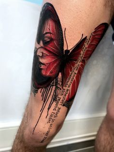 a man's leg with a red butterfly on it and some words written in black ink