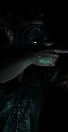 a man in the dark holding his hand out to touch something with it's fingers