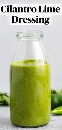 a green smoothie in a glass jar with the words cilantro lime dressing