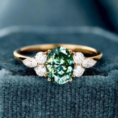 Teal color Moissanite Ring, 14k Solid Gold Ring, Moissanite Ring, Engagement Ring, Gift For Her, Natural Moissanite Promise Ring for Women  (in stock) - Metal: 14K Yellow Gold - Custom Color: Rose Gold, Yellow Gold, and White Gold  - Gross weight: 2.33g - Gold Weight: 2.02g - Gemstones: Moissanite - Moissanite CTW: 1.18ct (1pcs) - Moissanite size: 6mm*8mm - Moissanite CTW: 0.380 (6pcs) - Ring size: 7 - Ring Width: 20.17mm Approximately - Ring Height: 24.09mm Approximate Shipping It usually takes 2-3 weeks to make and 3-5 days to ship We apply a tracking number for every single package. Engraving You can order a custom engraving. (just contact me in advance) Teal Ring, Teal Rings, Solid Gold Ring, Ring Moissanite, Teal Color, Ring Engagement, Moissanite Ring, Moissanite Rings, Teal Colors