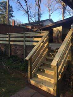 a wooden stair case in front of a house