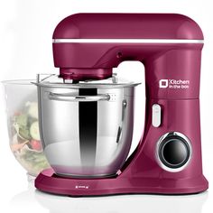 a red kitchen aid mixer with a bowl full of salad in it's center