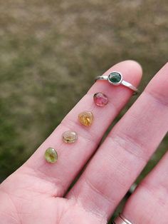 This gorgeous stackable ring features a beautiful little tourmaline gemstone set in a handcrafted bezel cup sitting atop a lightly hammered argentium silver band. Best part is, you get to choose your own stone! You let me know which stone you prefer from 1-4 and I'll make you a ring that looks like the example, but with the stone of your choice. You get to be part of the creative process with me! Gemstones measure between 5x6mm-5x7mm Follow this link to enter my shop: https://www.etsy.com/shop/barebranchjewelry Follow these links to see some of my other gemstone pieces: Teal moss kyanite: https://barebranchjewelry.etsy.com/listing/1267901671/moss-kyanite-ring-celestial-silver Herkimer diamond stacker: https://barebranchjewelry.etsy.com/listing/729433702/herkimer-diamond-ring-silver-solitai Tourmaline Birthstone Gemstones As Gift, Round Tourmaline Promise Ring, Tourmaline Birthstone Jewelry For Promise Ring, Tourmaline Birthstone Ring Gift, Handmade Tourmaline Gemstones, Silver Emerald Ring With Tourmaline Birthstone, Tourmaline Birthstone Rings, Tourmaline May Birthstone Jewelry, Tourmaline Birthstone Ring With Bezel Setting