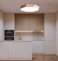 an empty kitchen with white cabinets and wood floors