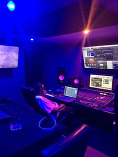 a man sitting at a desk in front of two monitors