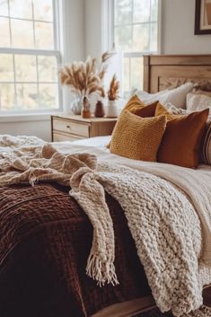 a bed with blankets and pillows in a bedroom