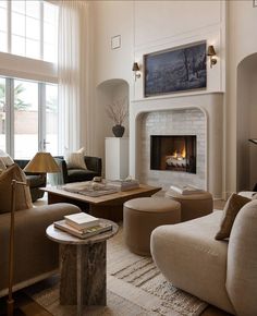 a living room filled with furniture and a fire place in the middle of a room