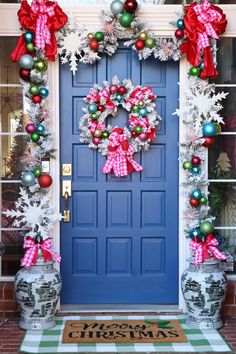 a blue front door decorated with christmas decorations