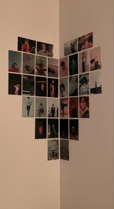 a heart made out of photos hanging on the side of a wall in a room