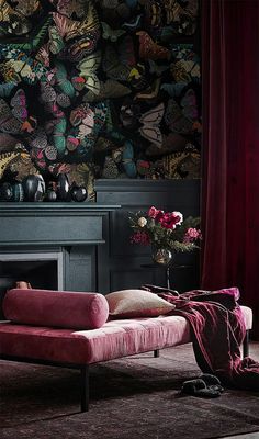 a living room filled with furniture and a wallpaper covered in colorful butterfly designs on the walls