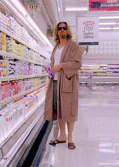 a woman is standing in the aisle of a grocery store