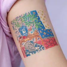 a woman with a tattoo on her arm that has an image of a table and flowers