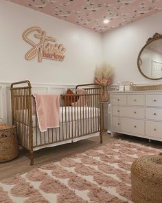 a baby's room with pink and white decor