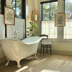 a white bath tub sitting next to a window