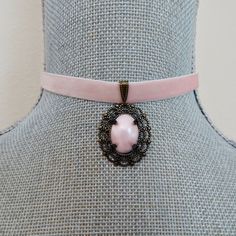 Lovely pastel pink velvet ribbon is threaded with an antique brass slider bail, linked with an ornate oval antique brass filigree with a prong set pink pearl cabochon focal.   The velvet ribbon closes at 13" on first link and with the matching extension chain will adjust an additional 2". There is a hook closure on the choker and a wire wrapped pink quartz bead dangle on the extension chain. The cabochon focal measures 1" X 1 1/8". All of my jewelry items come boxed, and ribbon tied and tagged for easy gifting. Pink Ribbon Jewelry For Formal Occasions, Pink Vintage Choker Jewelry, Pink Adjustable Oval Jewelry, Adjustable Pink Oval Jewelry, Adjustable Oval Pink Jewelry, Pink Heart-shaped Choker Gift, Pink Oval Victorian Jewelry, Vintage Pink Oval Necklace, Elegant Pink Cabochon Necklace