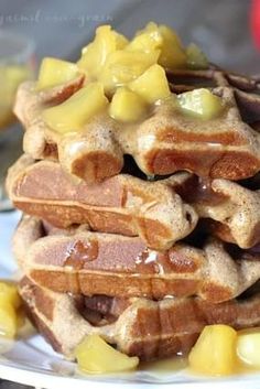 a stack of waffles with syrup on top