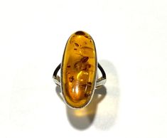 Gemstone Product Specifications Product Name: 925 Sterling Silver Ring Stone Name: Amber Stone Shape: Oval Shape Stone Size: 31x12 MM (-/+ 0.2 MM ) Color: Yellow Ring Size: 9 US Size Weight: 8.44 Gram. Transparency opaque Condition: Excellent Remarks: Beautiful Luster. Beautiful Colors. No Spots Clean. No Cracks or damages. Gift Material. For Similar Products and other beautiful products please browse our Shop. You can find the variety of 'Not-so-Easy to find' products at one place. Handmade Amber Sterling Silver Rings, Handmade Oval Amber Rings, Oval Cabochon Ring With Natural Inclusions For Gift, Handmade Amber Oval Cabochon Rings, Yellow Ring, Yellow Rings, Citrine Pendant, Vintage Style Rings, Ring Stone