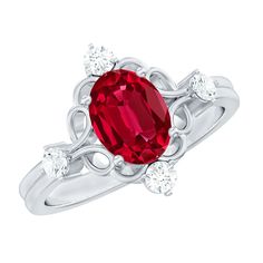 a ring with an oval red stone surrounded by three white diamonds on the sides and in the center