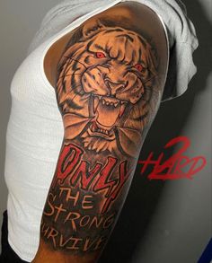 a man with a tiger tattoo on his arm that says only the strong are born