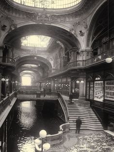 an old black and white photo of the inside of a building with water in it