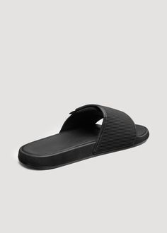 Finally, Tall Men's Slides Made Just for You The Perfect Fit for Tall Guys Whether lounging around the pool or trekking through the house, our Adjustable Slides for men are the casual slip-ons you need for your larger feet. Featuring an adjustable velcro strap with a cushioned footbed, these slides are perfect for men who need that extra bit of room and comfort that lasts all day.• EVA blown-out sole for lightweight cushioning• Adjustable velcro strap for a customizable fit• Cushioned footbed fo Black Slip-on Flip Flops For Leisure, Comfortable Black Slippers For Leisure, Comfortable Black Slippers For Casual Wear, Comfortable Breathable Black Slippers, Black Non-slip Slides For Leisure, Black Slip-resistant Slides For Vacation, Black Slides With Textured Footbed For Outdoor, Black Outdoor Slippers With Textured Footbed, Black Textured Footbed Slippers For Outdoor