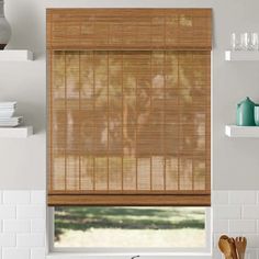 a kitchen window covered in bamboo blinds