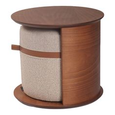 a round wooden table with a white and brown ottoman on it's side, in front of a white background