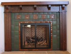 a fireplace with a fire in it and tile on the top part of the mantle