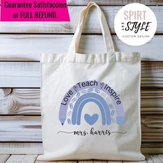 a tote bag with the words love teach inspire and an image of a rainbow