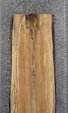 a piece of wood sitting on top of a cement floor