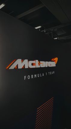 the logo for india formula 1 team is displayed in front of a black wall with orange and white letters