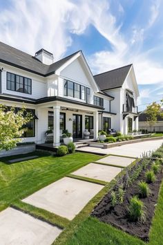 a large white house sitting on top of a lush green field