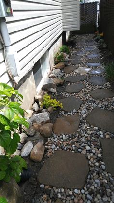 a stone path in front of a house