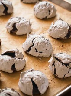 chocolate cookies with white frosting are on a baking sheet, ready to be baked