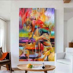 an abstract painting hangs in the living room