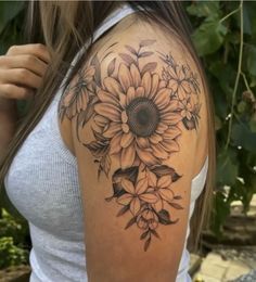 a woman with a sunflower tattoo on her shoulder