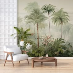 a living room with palm trees on the wall and a coffee table in front of it