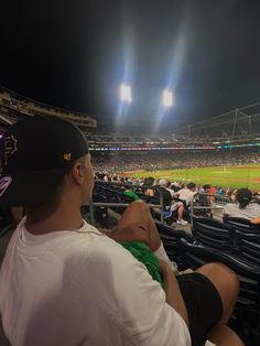 a man sitting in the stands at a baseball game