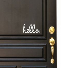 a black door with the word hello written on it