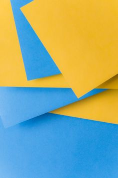 blue and yellow paper stacked on top of each other