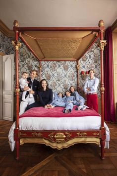 the family is posing for a photo on their bed