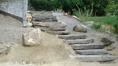 stone steps lead up to a rock garden