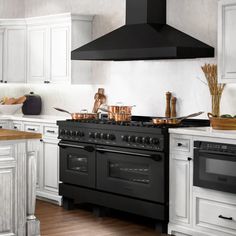 a black stove top oven sitting inside of a kitchen next to white cabinets and counter tops